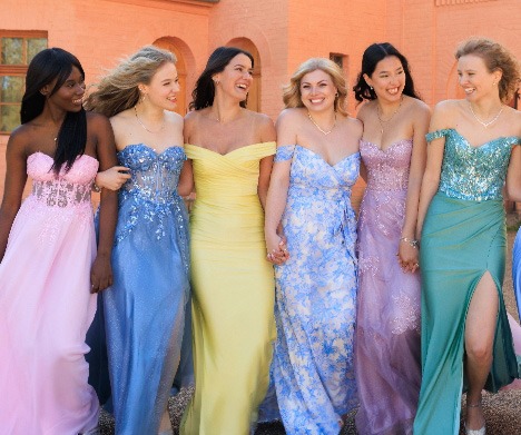 Fünf Frauen in eleganten, bodenlangen Brautkleidern in Blau, Gelb, Hellblau, Rosa und Grün